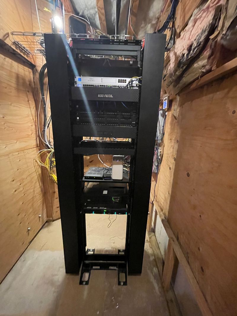Full-height enclosed server rack installed in utility closet